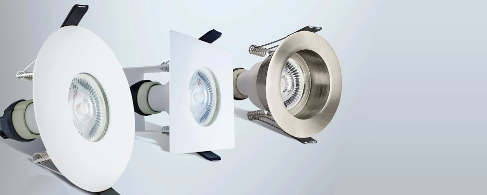 Various Evofire fire-rated downlight models on a grey background
